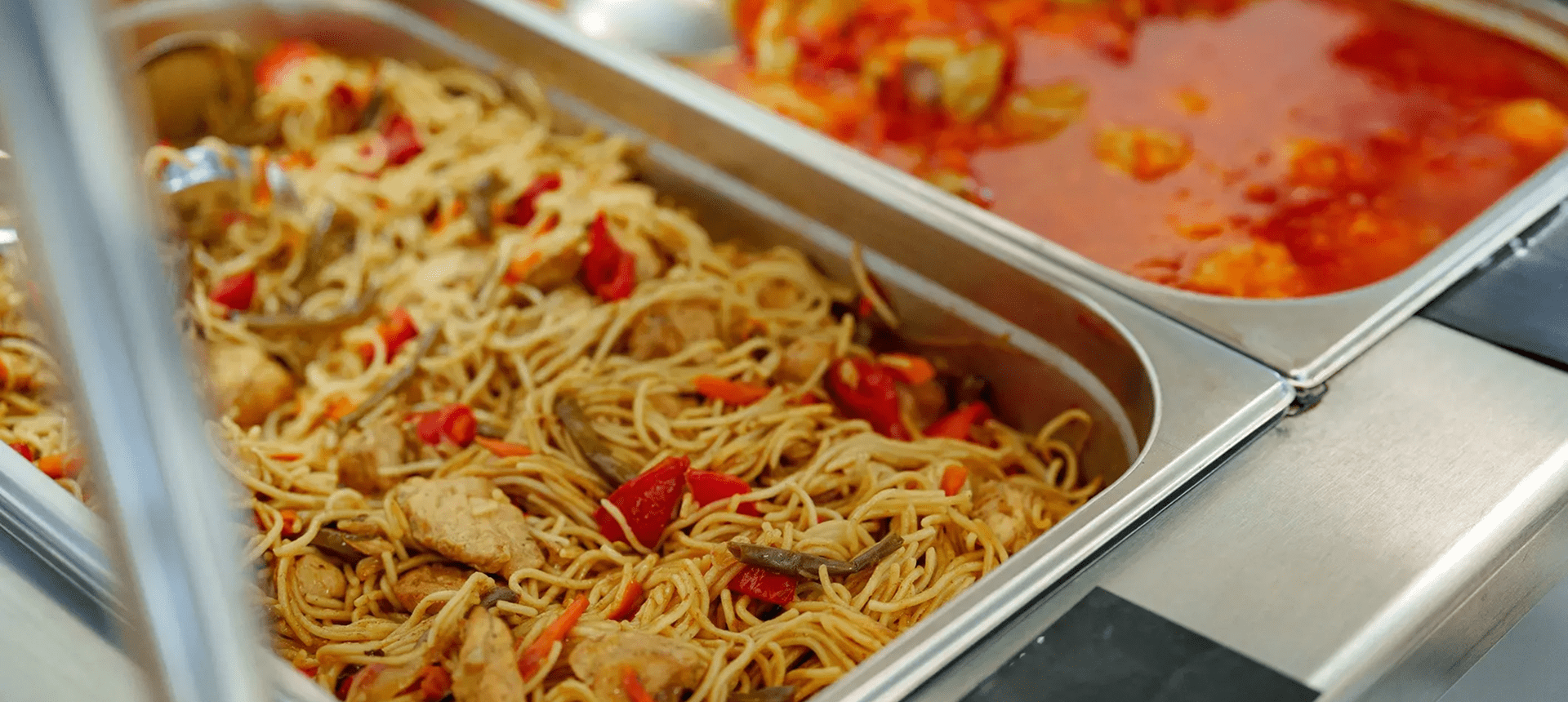 Buffet trays with noodles and stew